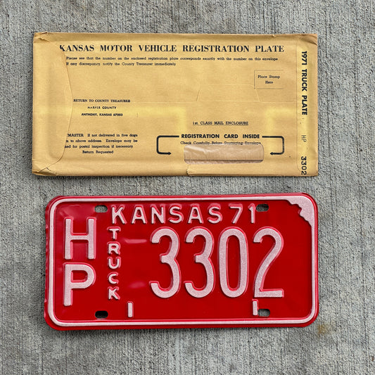 Photo of a 1971 Kansas Truck License Plate Auto Tag Garage Decor Vintage New Old Stock With Envelope HP 3302 with original patina