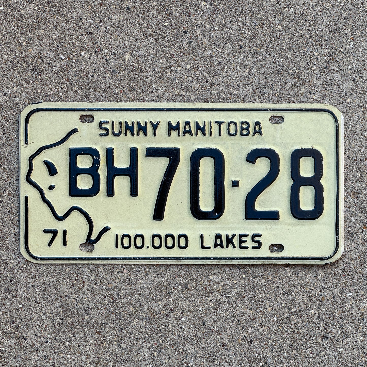 Photo of a 1971 Manitoba License Plate Auto Tag Garage Decor Vintage Bison Graphic BH 70 28 with original patina