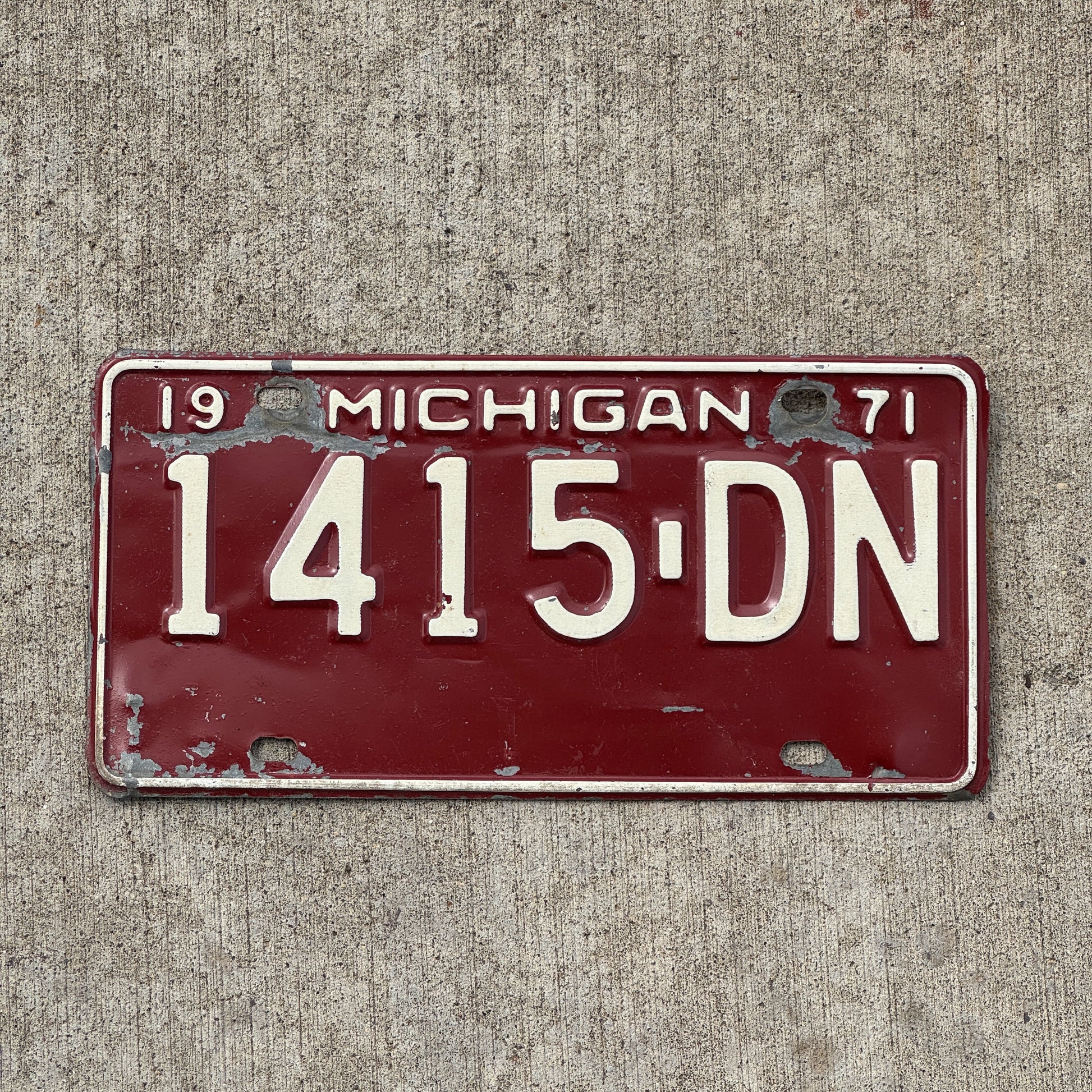 Photo of a 1971 Michigan Commercial License Plate Auto Tag Garage Decor Vintage 1415 DN with original patina