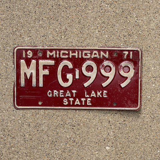 Photo of a 1971 Michigan License Plate Auto Tag 1 Vintage Garage Repeat Repeating MFG 999 with original patina