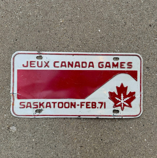 Photo of a 1971 Saskatoon Jeux Canada Games Saskatchewan Booster License Plate Auto Tag Garage Decor Vintage Maple Leaf Graphic Steel with original patina