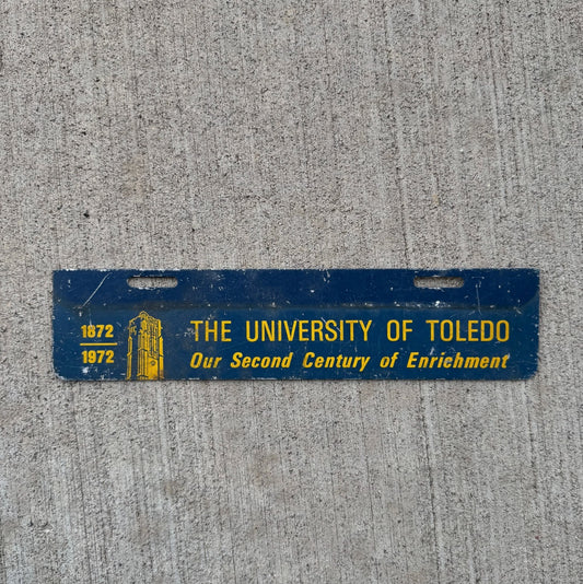 Photo of a 1972 University of Toledo Ohio License Plate Topper Auto Tag Garage Decor Vintage College Rockets Centennial with original patina