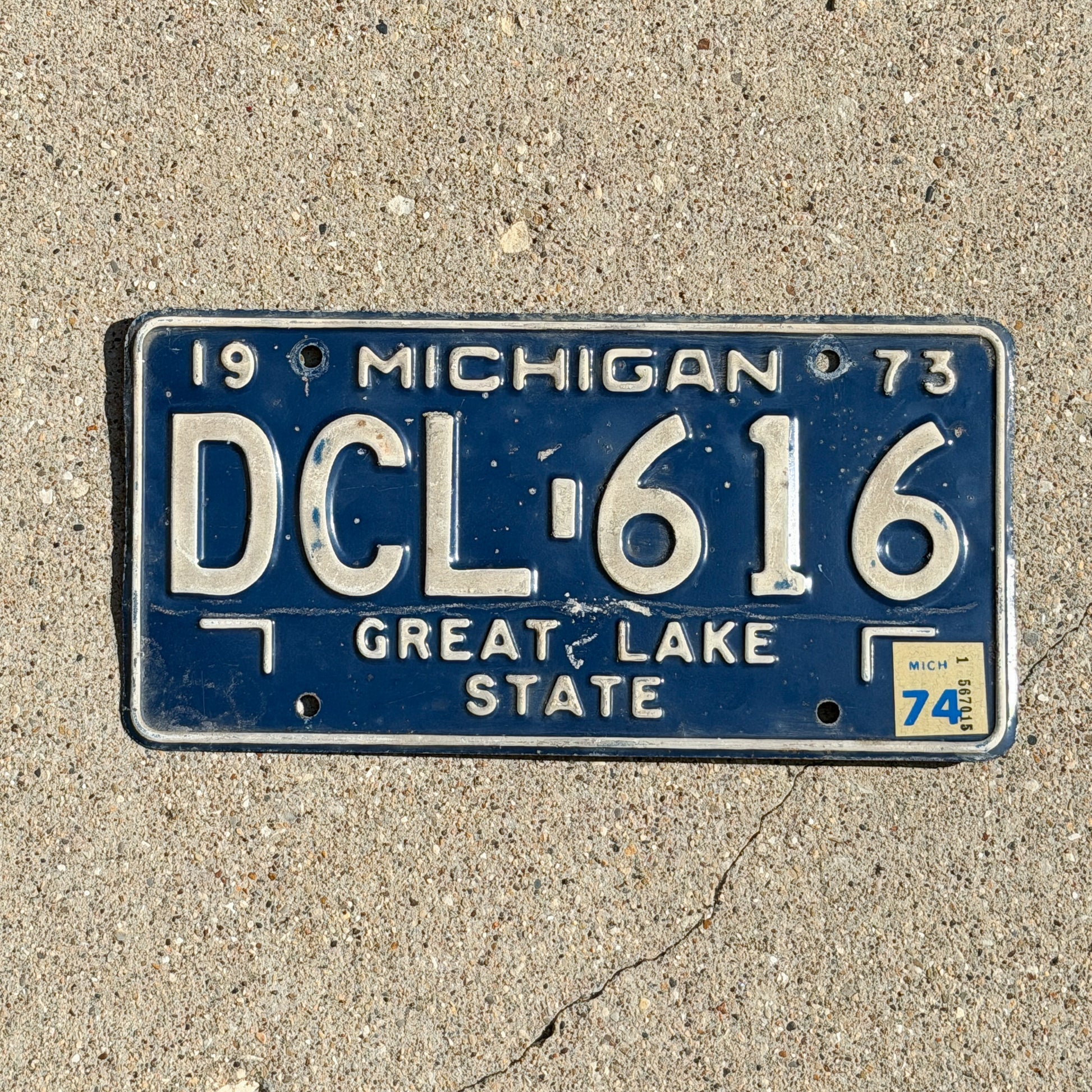 Photo of a 1973 1974 Michigan License Plate Auto Tag Garage Decor Vintage DCL 616 with original patina