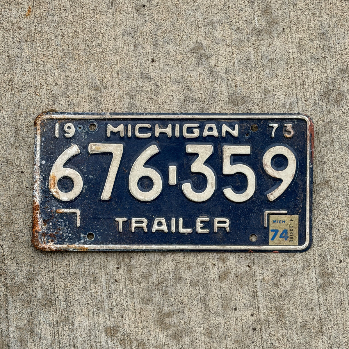 Photo of a 1973 1974 Michigan Trailer License Plate Auto Tag Garage Decor Vintage 676 359 with original patina