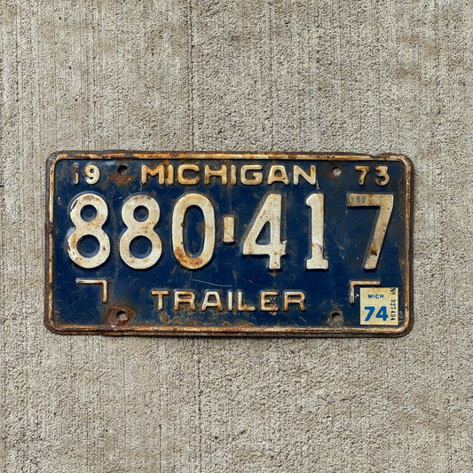 Photo of a 1973 1974 Michigan Trailer License Plate Auto Tag Garage Decor Vintage 880 417 with original patina