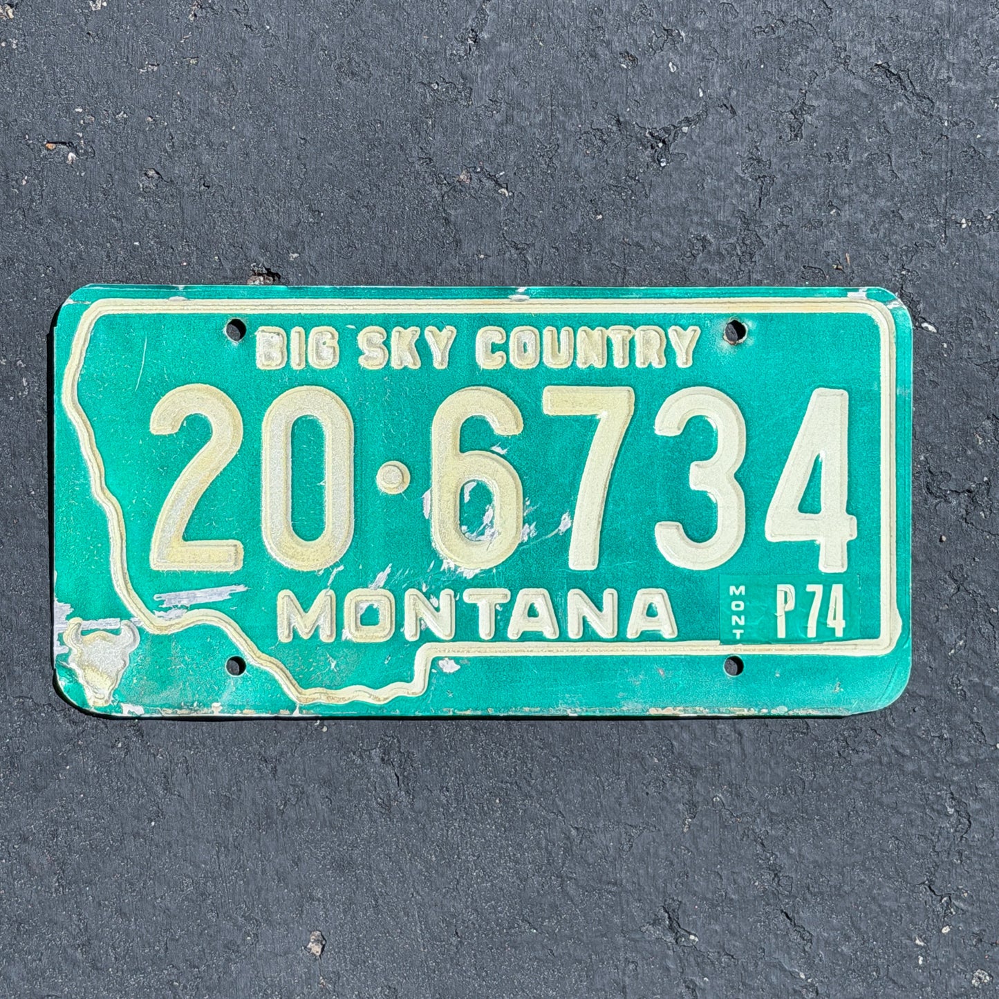 Photo of a 1973 1974 Montana License Plate Auto Tag Garage Decor Vintage State Shape 20 6734 with original patina