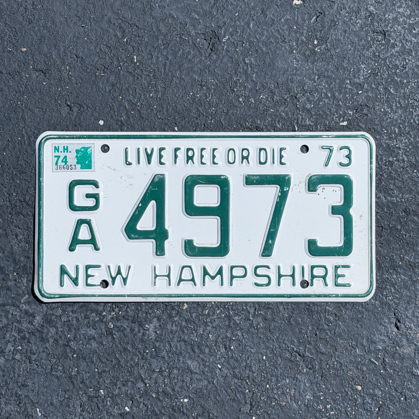 Photo of a 1973 1974 New Hampshire License Plate Auto Tag Garage Decor Vintage GA 4973 with original patina