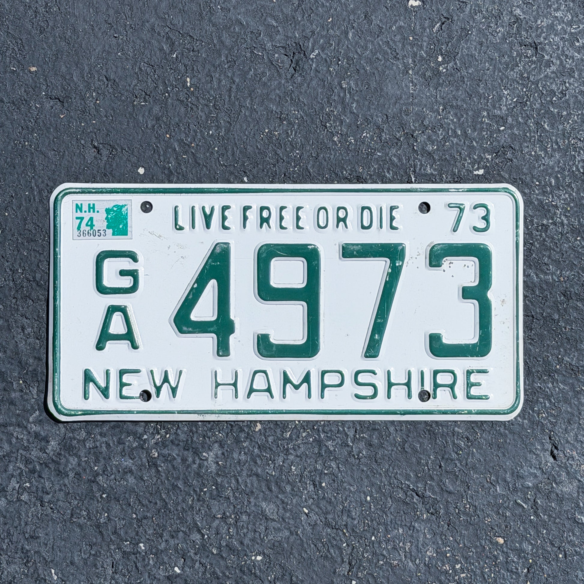Photo of a 1973 1974 New Hampshire License Plate Auto Tag Garage Decor Vintage GA 4973 with original patina