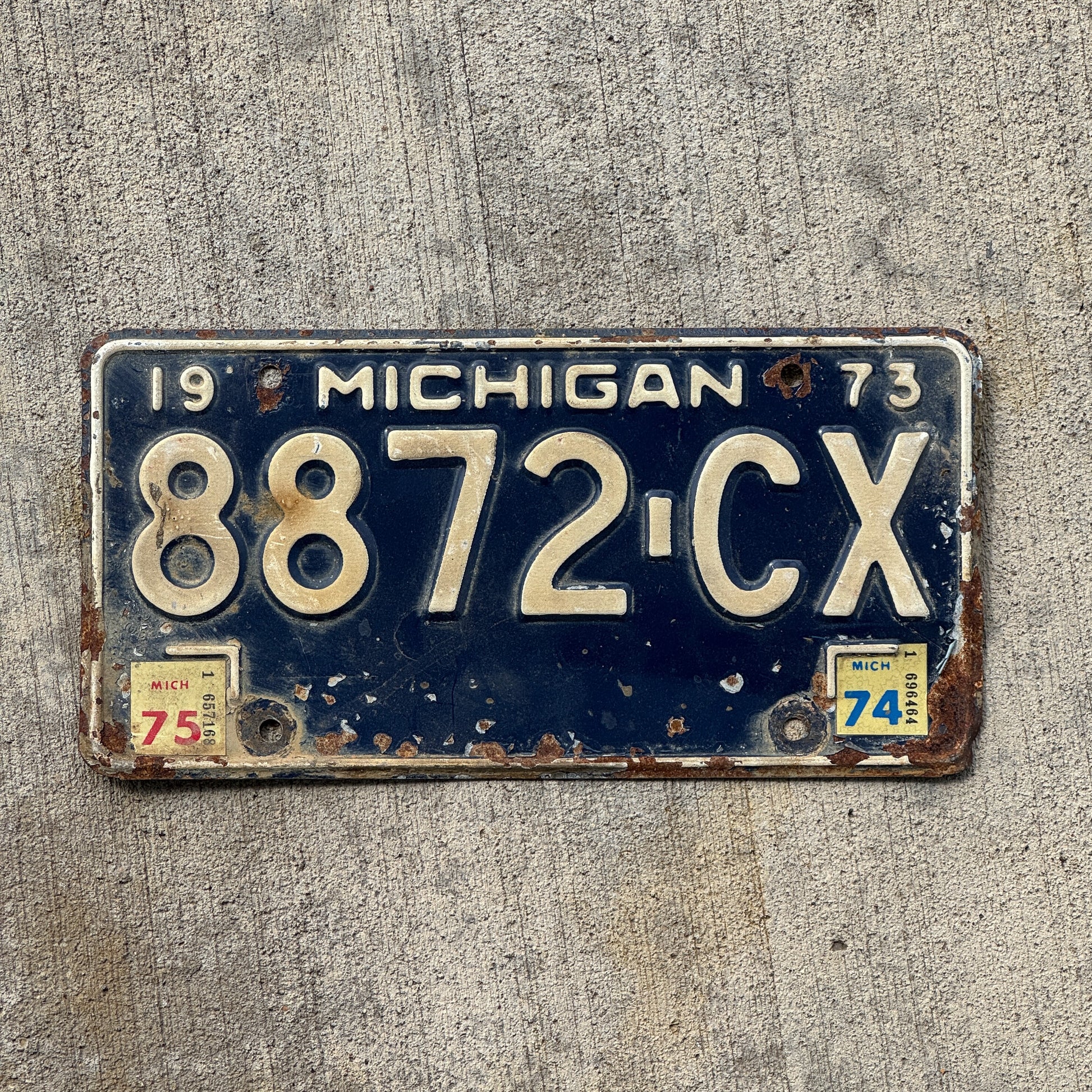 Photo of a 1973 1975 Michigan Commercial License Plate Auto Tag Garage Decor Vintage 8872 CX with original patina