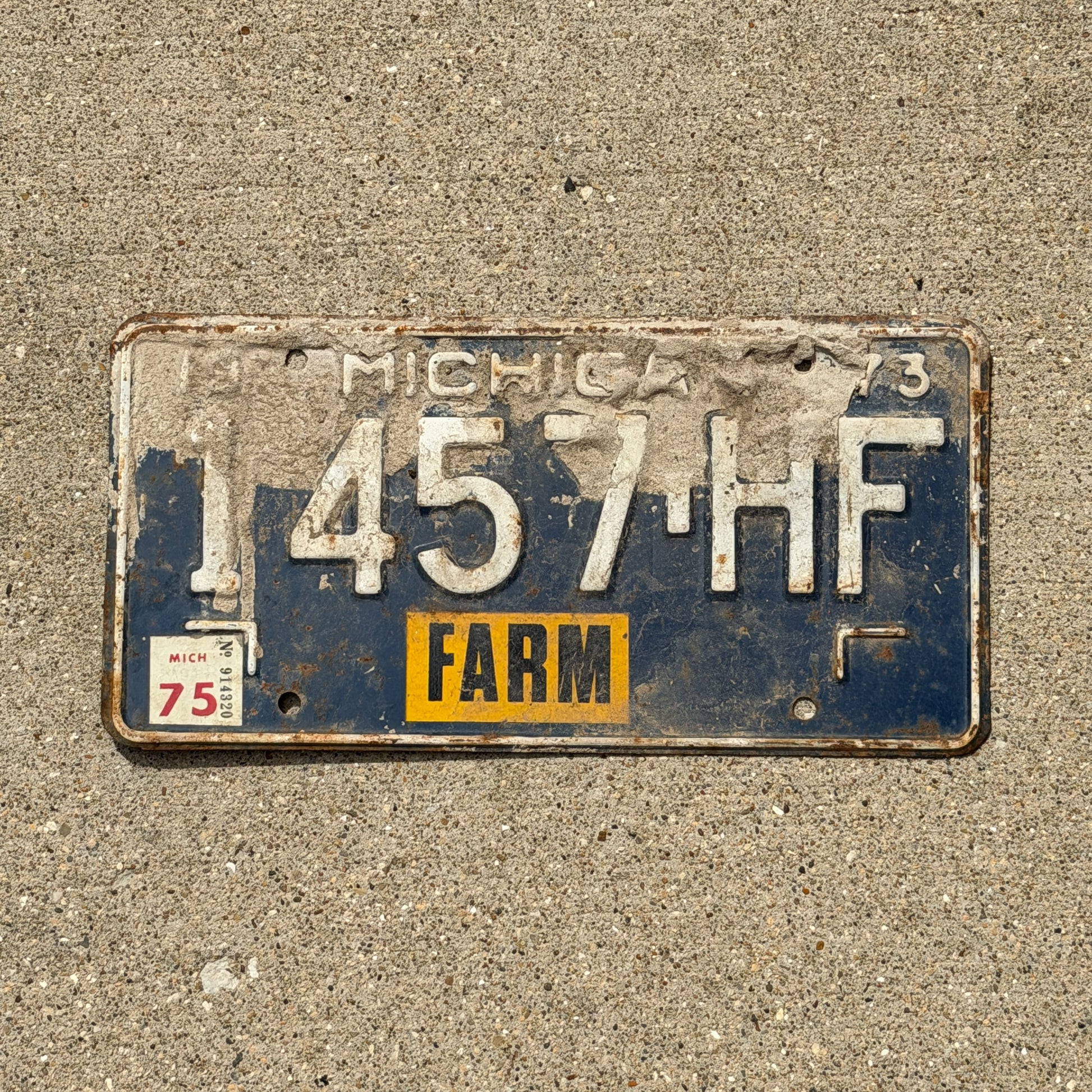 Photo of a 1973 1975 Michigan Farm License Plate Auto Tag Garage Decor Vintage 1457 HF with original patina