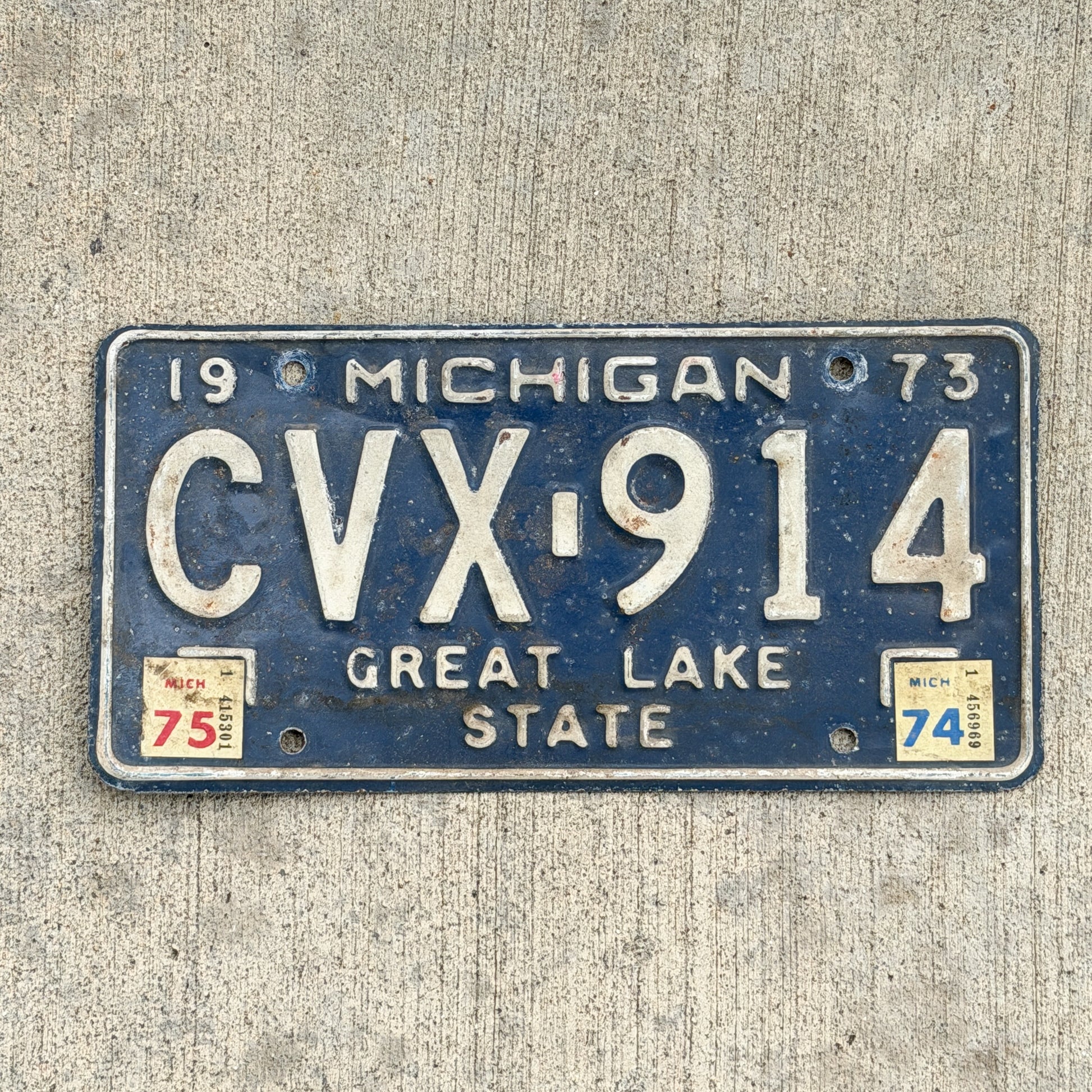 Photo of a 1973 1975 Michigan License Plate Auto Tag Garage Decor Vintage CVX 914 with original patina