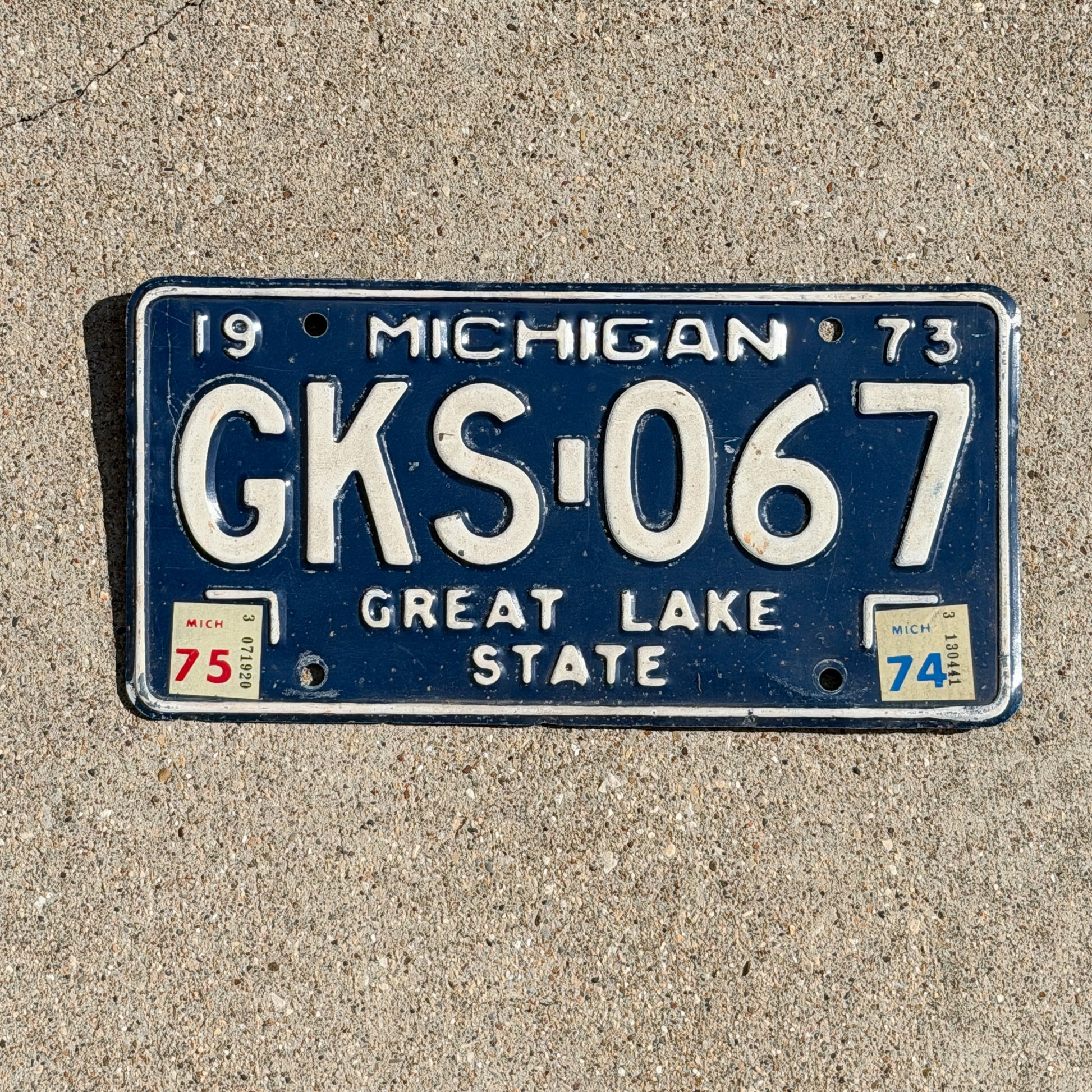 Photo of a 1973 1975 Michigan License Plate Auto Tag Garage Decor Vintage GKS 067 with original patina