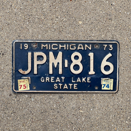 Photo of a 1973 1975 Michigan License Plate Auto Tag Garage Decor Vintage JPM 816 with original patina
