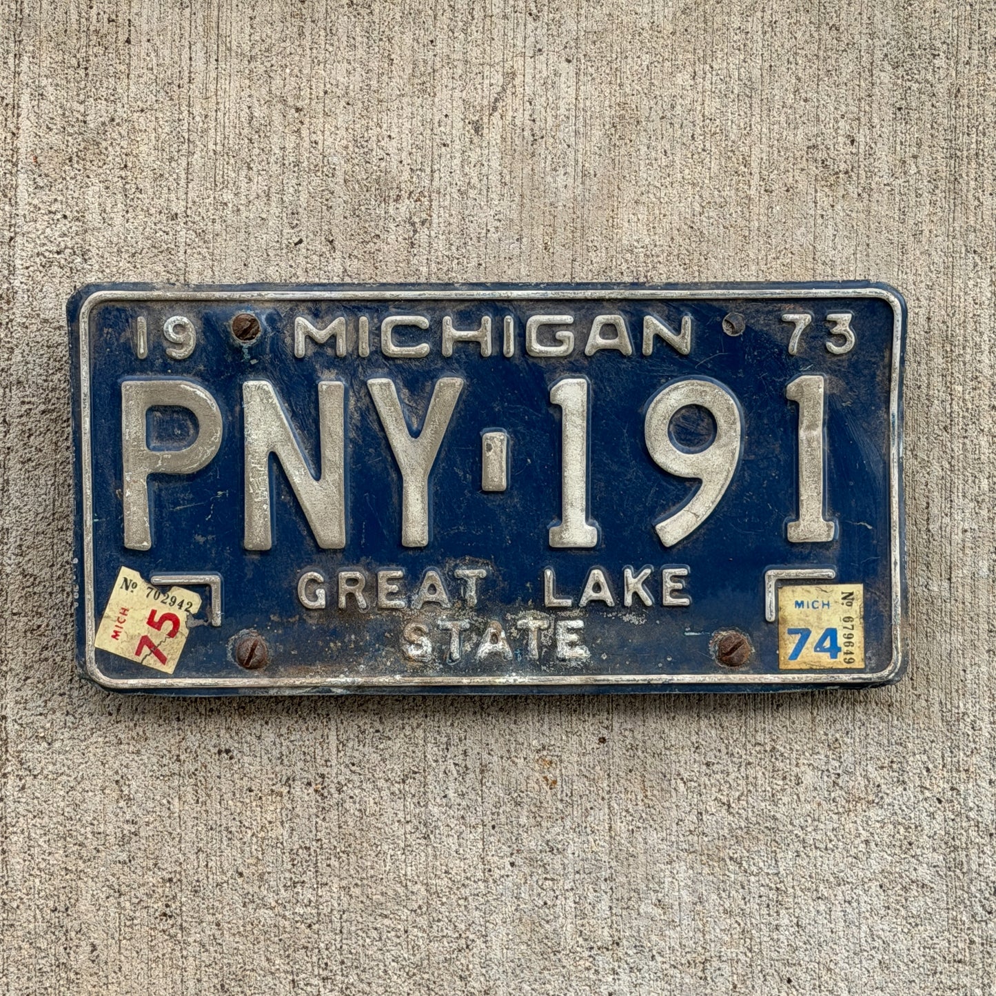Photo of a 1973 1975 Michigan License Plate Auto Tag Garage Decor Vintage PNY 191 with original patina