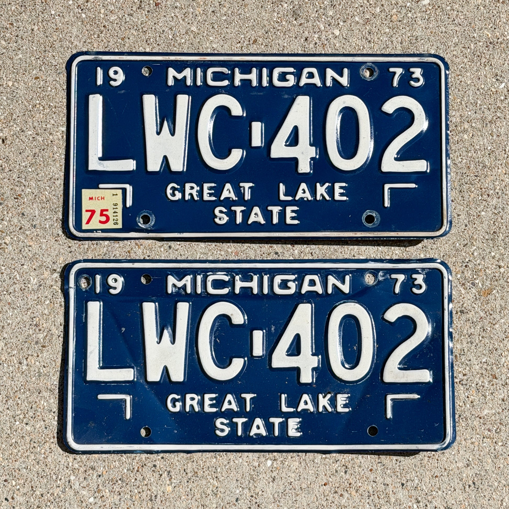Photo of a 1973 1975 Michigan License Plate Pair Auto Tag Garage Decor Vintage LWC 402 with original patina