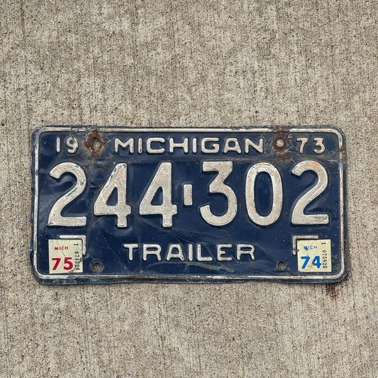 Photo of a 1973 1975 Michigan Trailer License Plate Auto Tag Garage Decor Vintage 244 302 with original patina