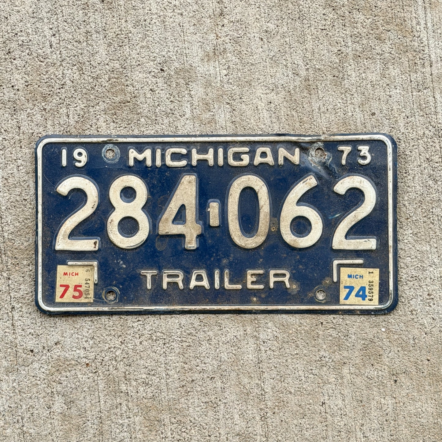 Photo of a 1973 1975 Michigan Trailer License Plate Auto Tag Garage Decor Vintage 284 062 with original patina