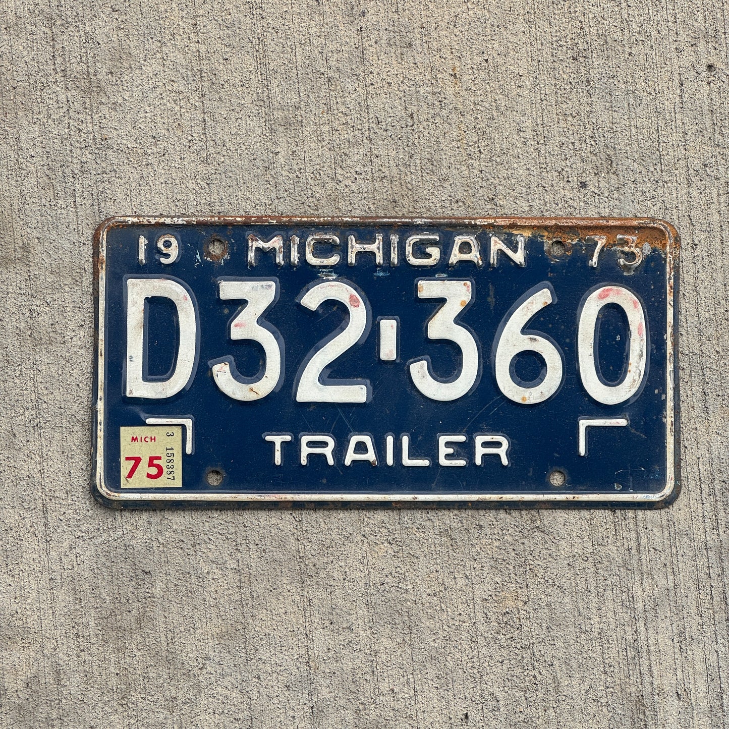 Photo of a 1973 1975 Michigan Trailer License Plate Auto Tag Garage Decor Vintage D32 360 with original patina