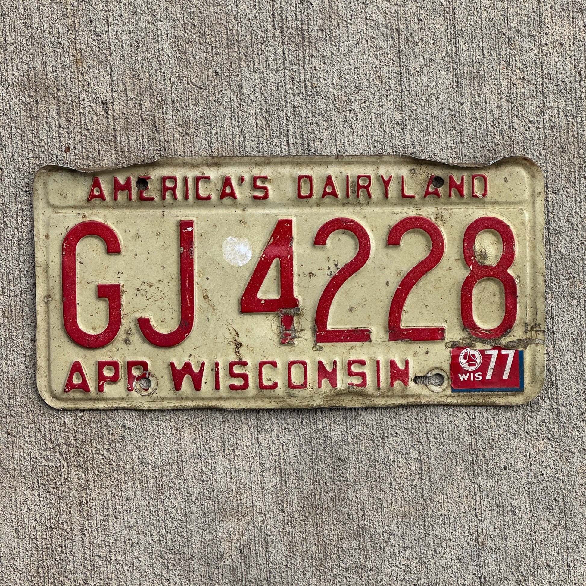 Photo of a 1973 1977 Wisconsin License Plate Auto Tag Garage Decor Vintage GJ 4228 with original patina