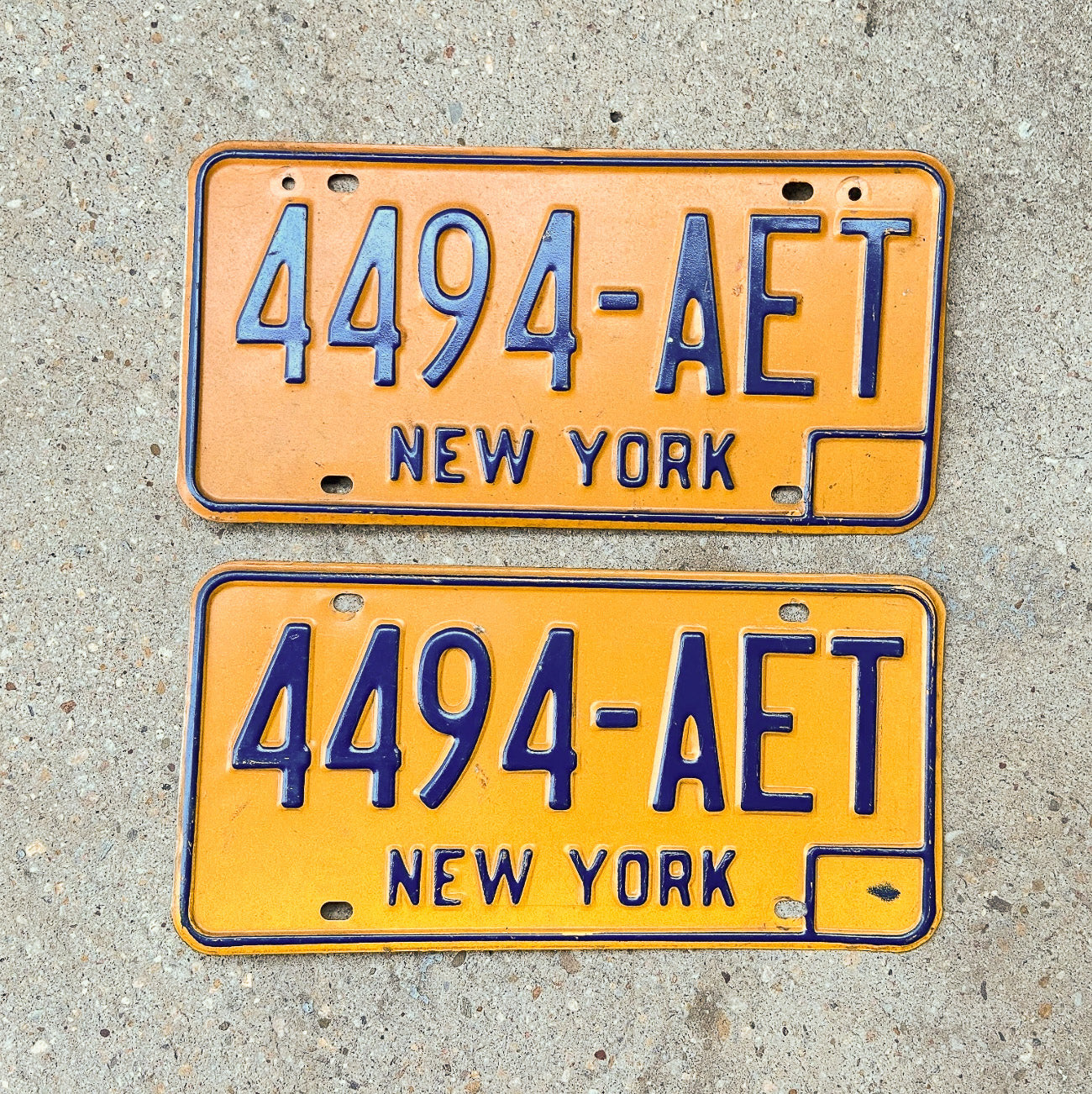 Photo of a 1973 1986 New York License Plate Auto Tag Garage Decor Vintage YOM DMV Clear 4494 AET with original patina