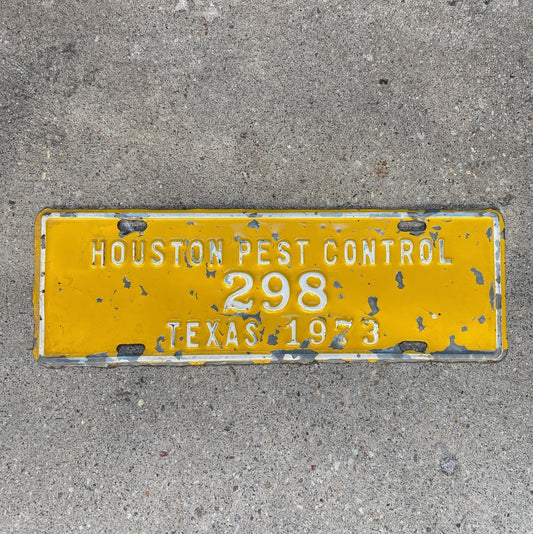 Photo of a 1973 Houston Texas License Plate Topper Auto Tag Garage Decor Vintage Pest Control Yellow Bugs Rodents 298 with original patina