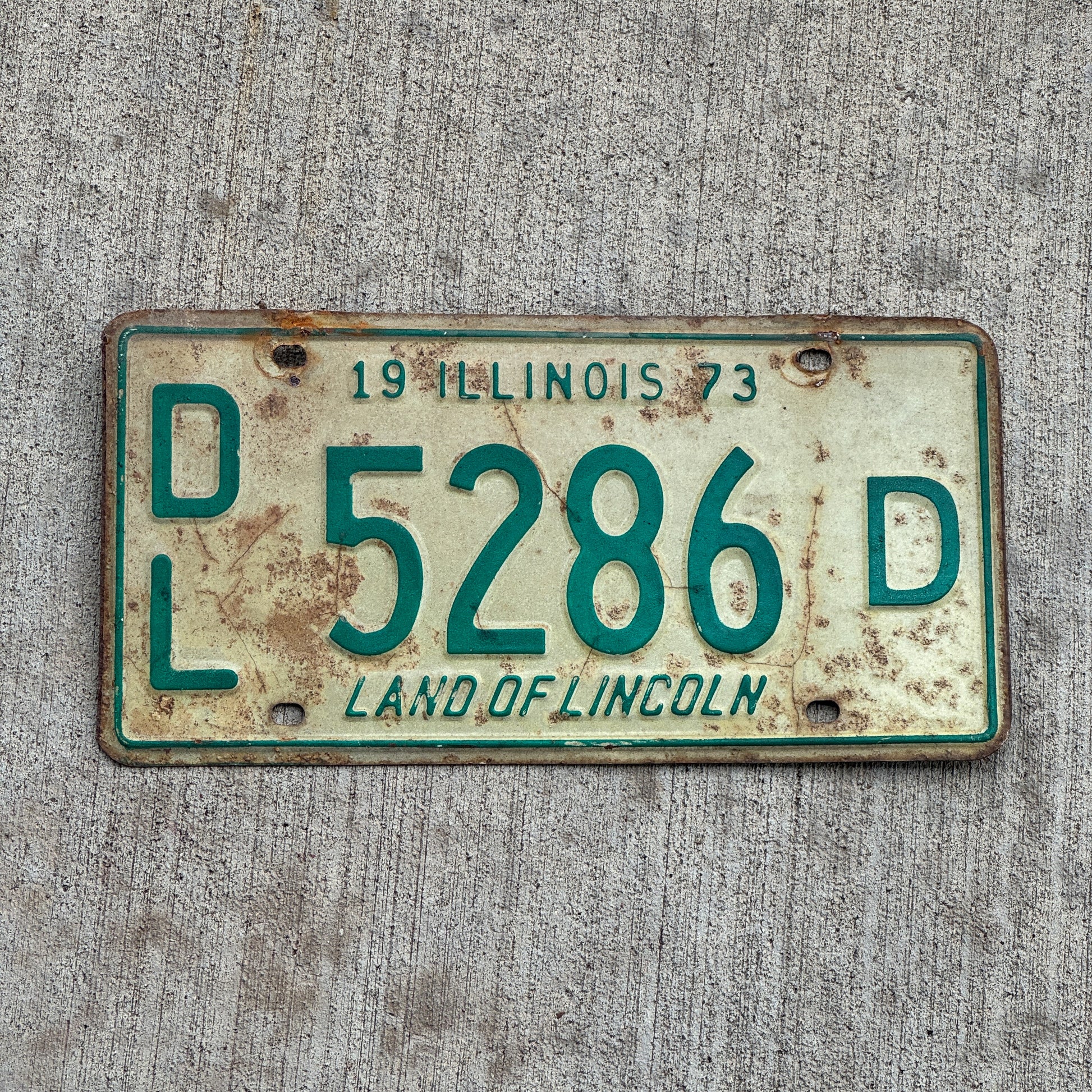 Photo of a 1973 Illinois Dealer License Plate Auto Tag 1 Vintage Garage 5286 D with original patina
