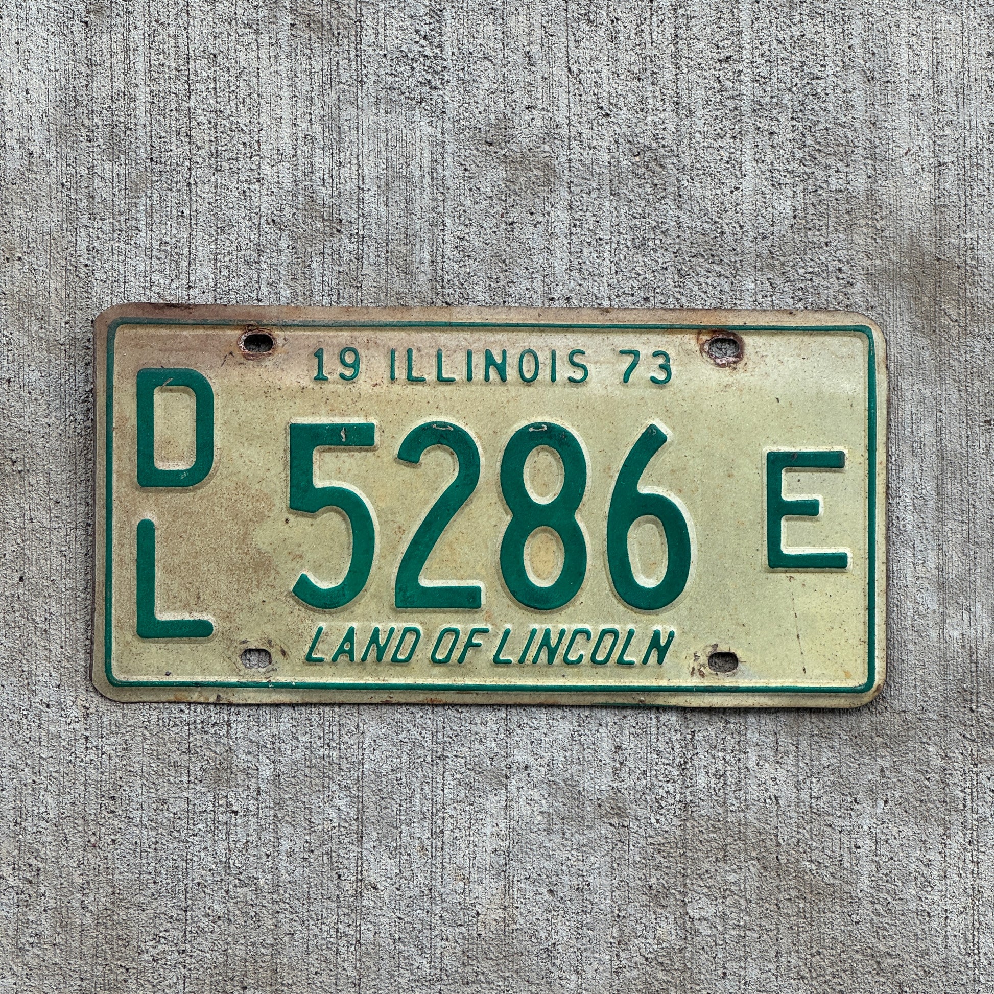 Photo of a 1973 Illinois Dealer License Plate Auto Tag 1 Vintage Garage 5286 E with original patina