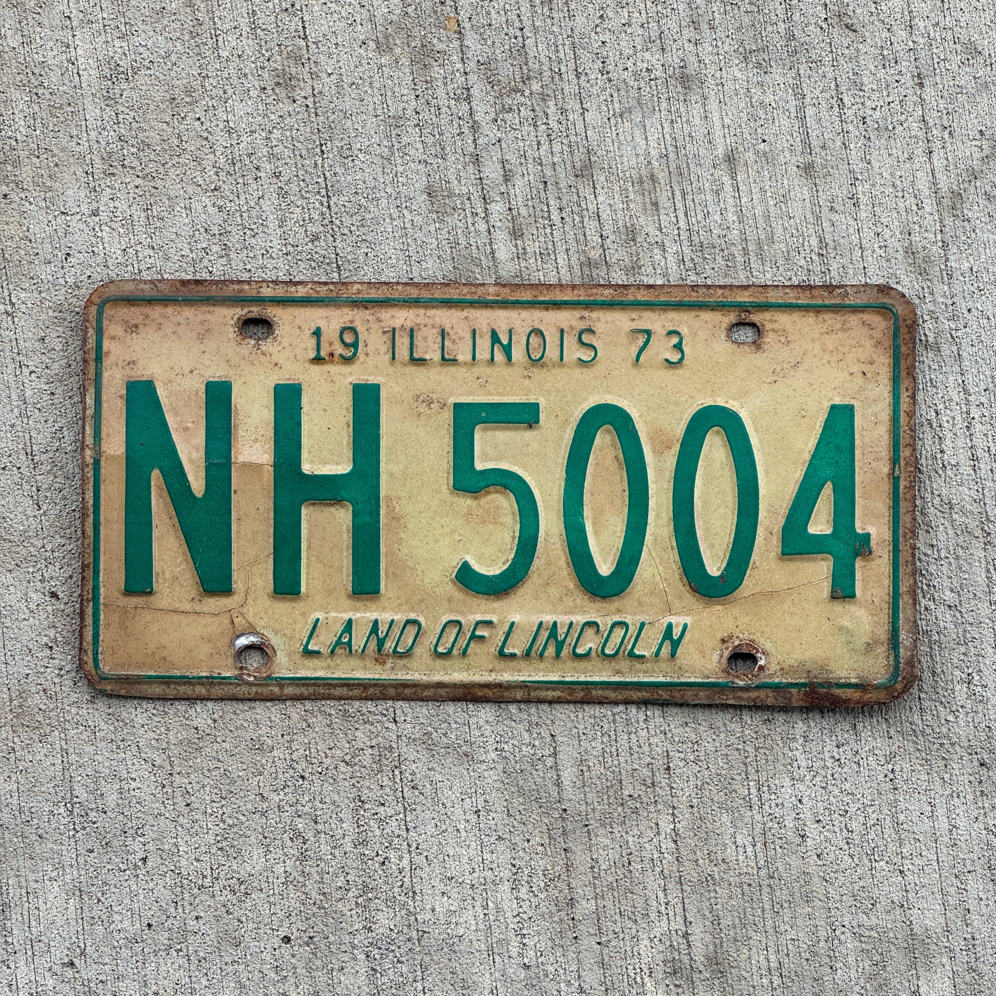 Photo of a 1973 Illinois License Plate Auto Tag 2 Vintage Garage NH 5004 with original patina