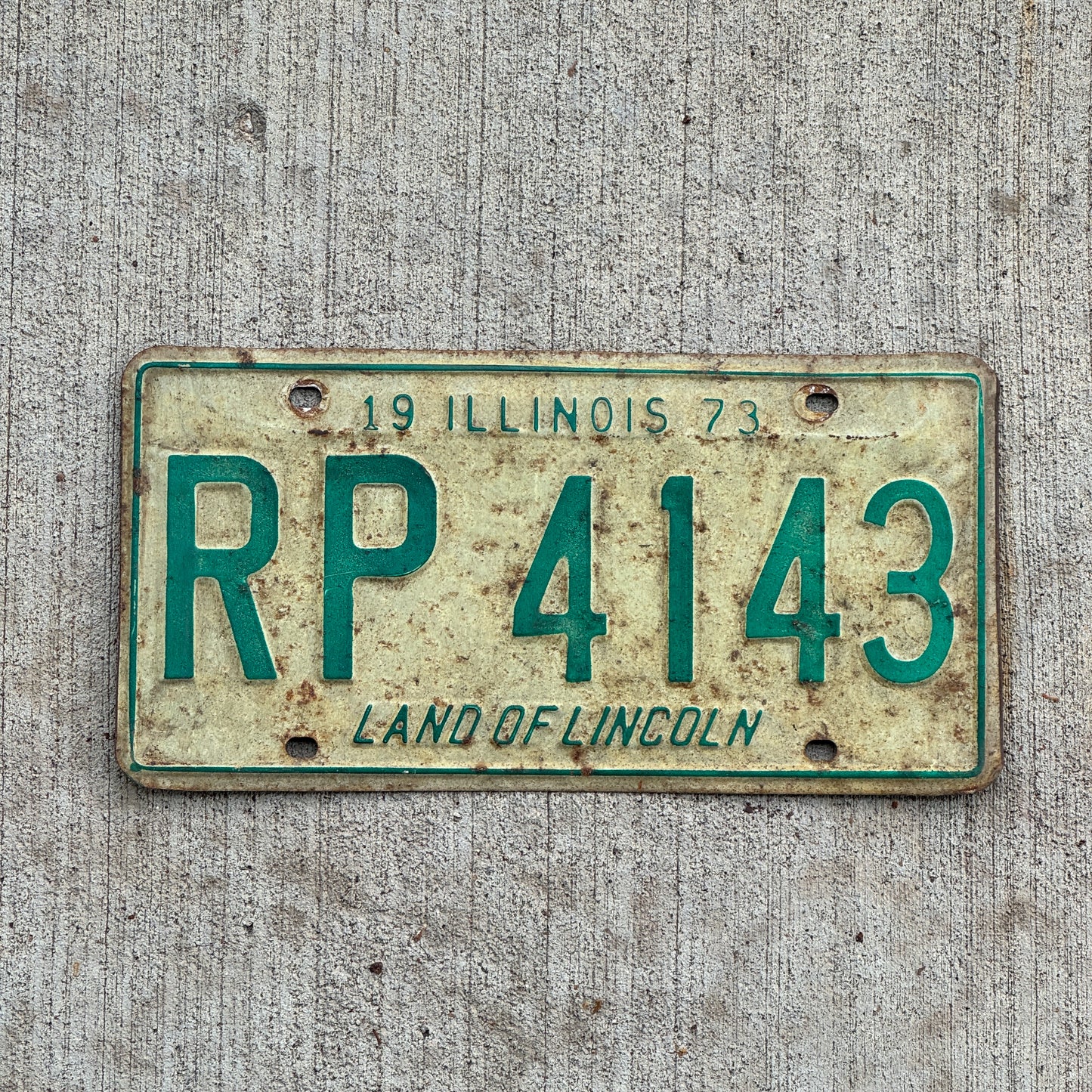 Photo of a 1973 Illinois License Plate Auto Tag 2 Vintage Garage RP 4143 with original patina