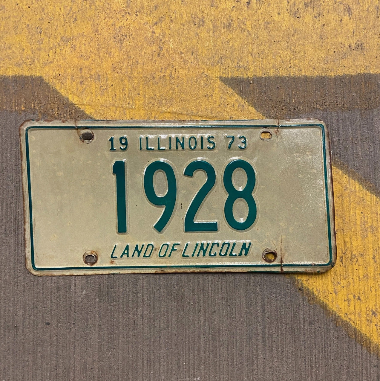 Photo of a 1973 Illinois License Plate Auto Tag Garage Decor Vintage Low Number Four Digit 1928 with original patina