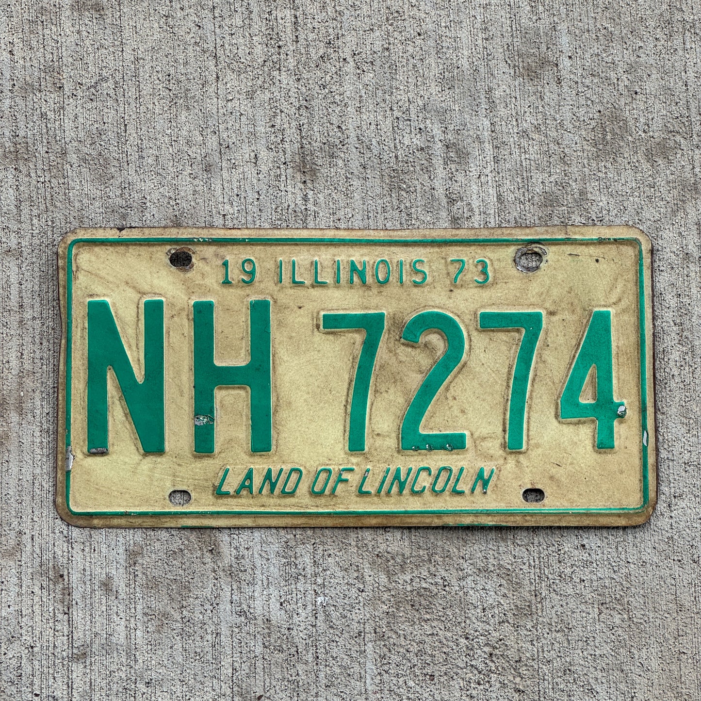 Photo of a 1973 Illinois License Plate Auto Tag Garage Decor Vintage NH 7274 with original patina
