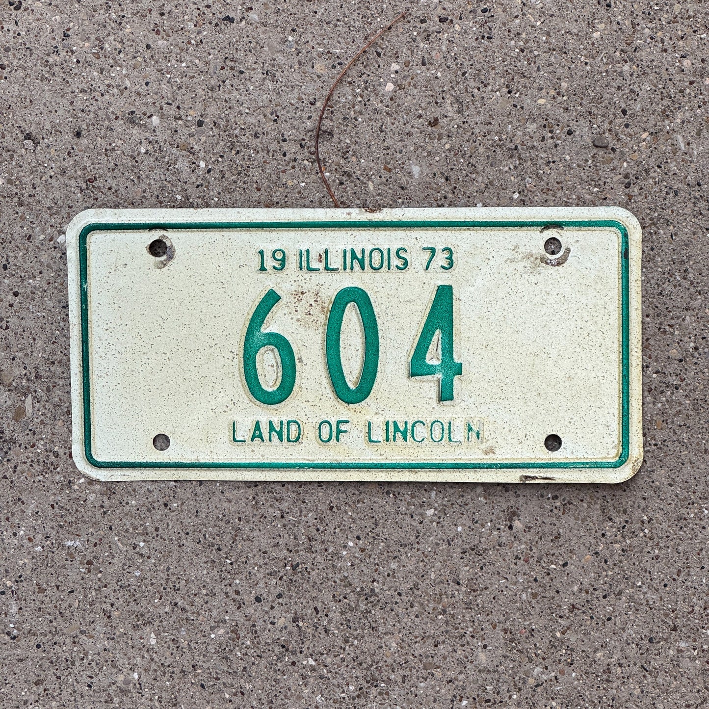 Photo of a 1973 Illinois Motorcycle License Plate Auto Tag Garage Decor Vintage Low Number Three Digit 604 with original patina