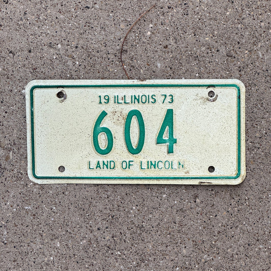 Photo of a 1973 Illinois Motorcycle License Plate Auto Tag Garage Decor Vintage Low Number Three Digit 604 with original patina