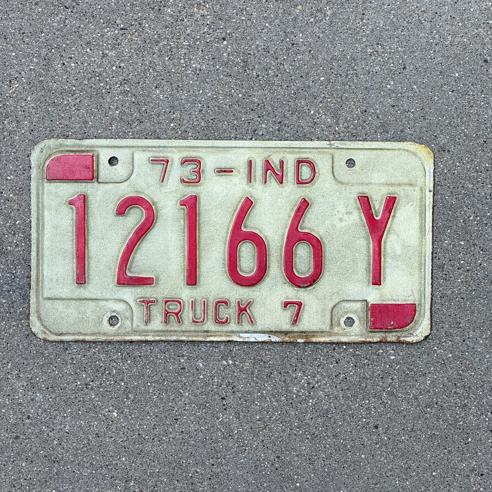 Photo of a 1973 Indiana Truck License Plate Auto Tag Garage Decor Vintage 12166 Y with original patina