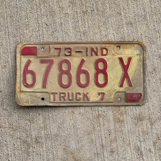 Photo of a 1973 Indiana Truck License Plate Auto Tag Garage Decor Vintage 67868 X with original patina