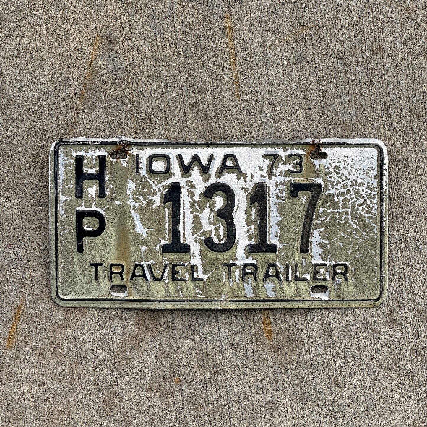 Photo of a 1973 Iowa Travel Trailer License Plate Auto Tag Garage Decor Vintage HP 1317 with original patina