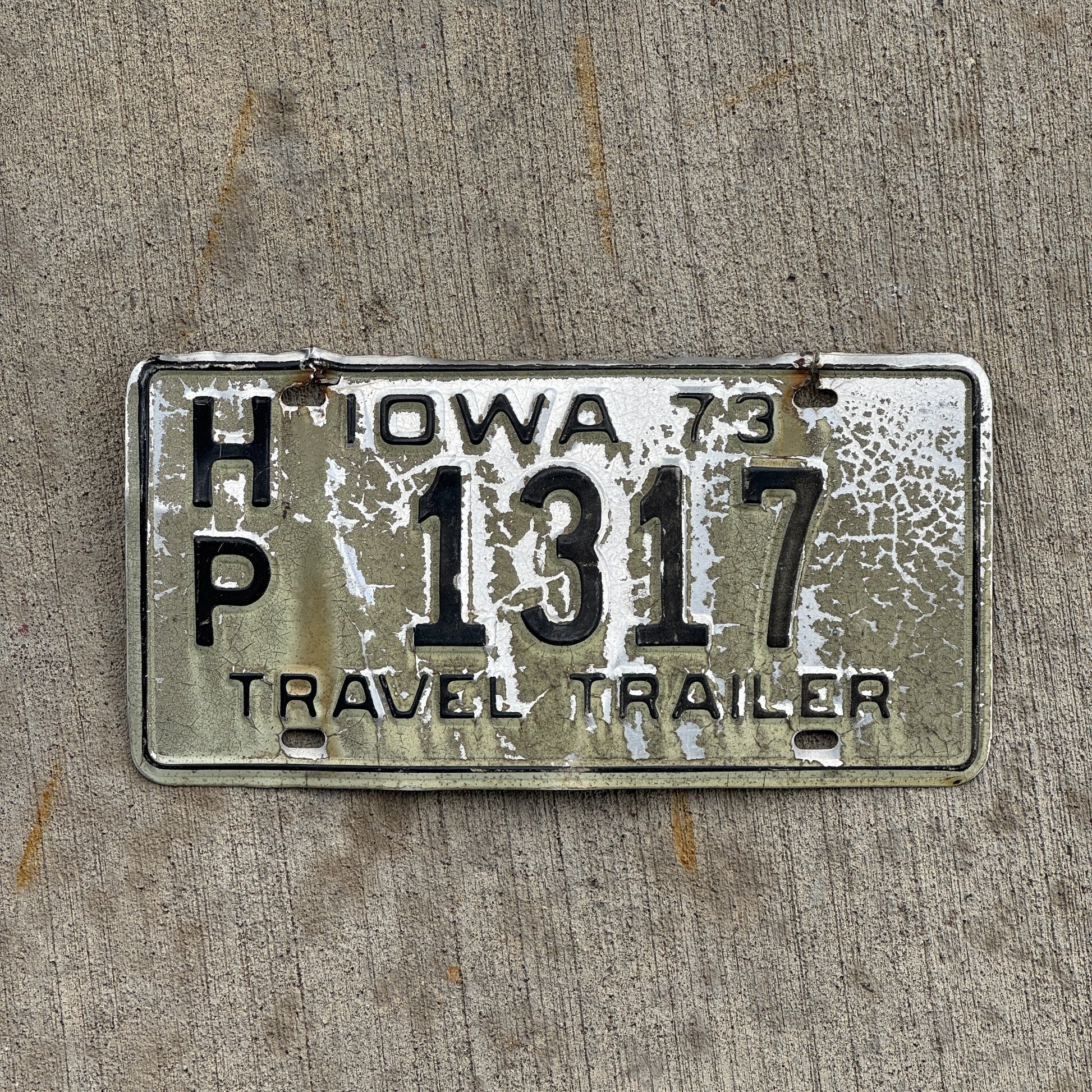 Photo of a 1973 Iowa Travel Trailer License Plate Auto Tag Garage Decor Vintage HP 1317 with original patina