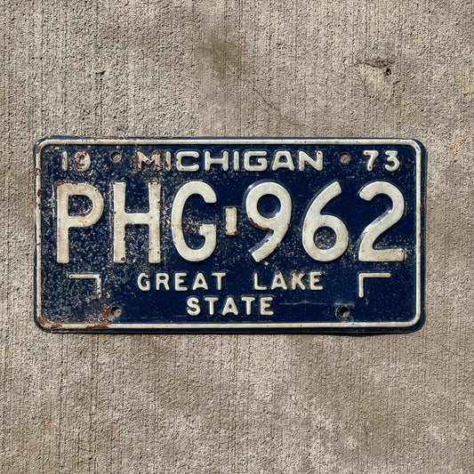 Photo of a 1973 Michigan License Plate Auto Tag Garage Decor Vintage PHG 962 with original patina