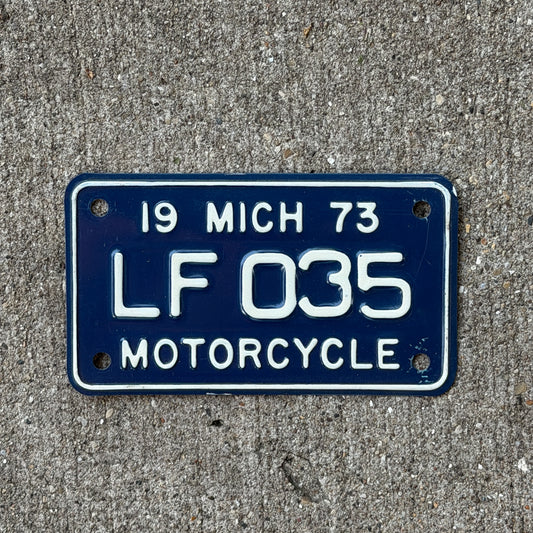 Photo of a 1973 Michigan Motorcycle License Plate Auto Tag Garage Decor Vintage LF 035 with original patina
