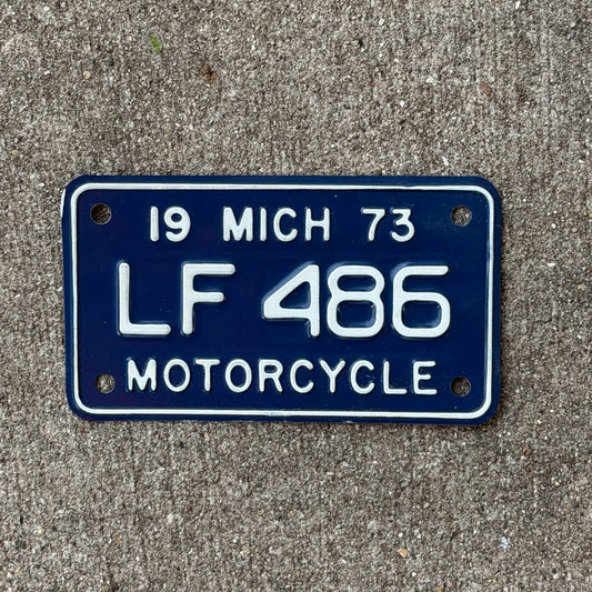 Photo of a 1973 Michigan Motorcycle License Plate Auto Tag Garage Decor Vintage LF 486 with original patina