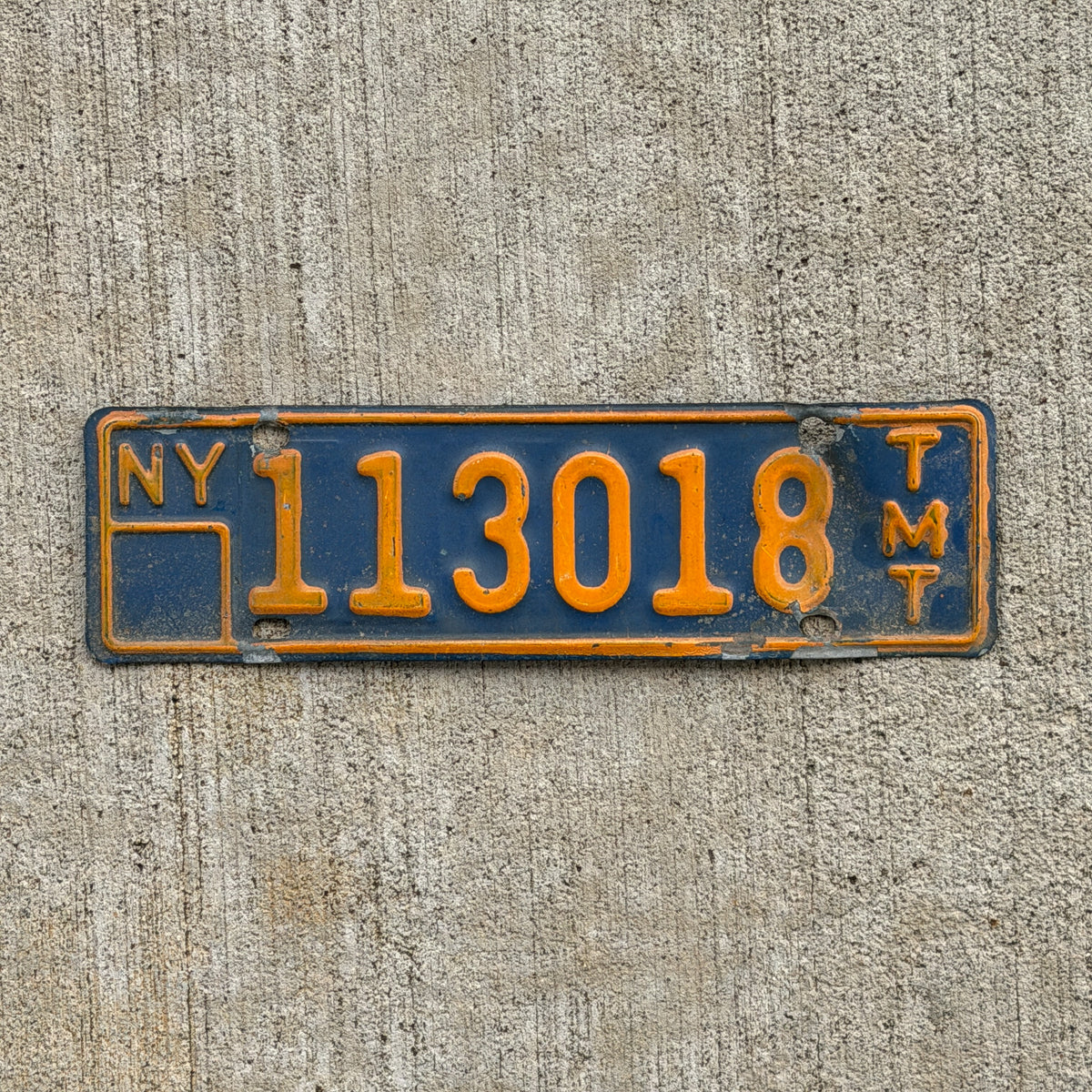 Photo of a 1973 New York Truck Mile Tax License Plate Auto Tag Garage Decor Vintage Series 7 113018 with original patina