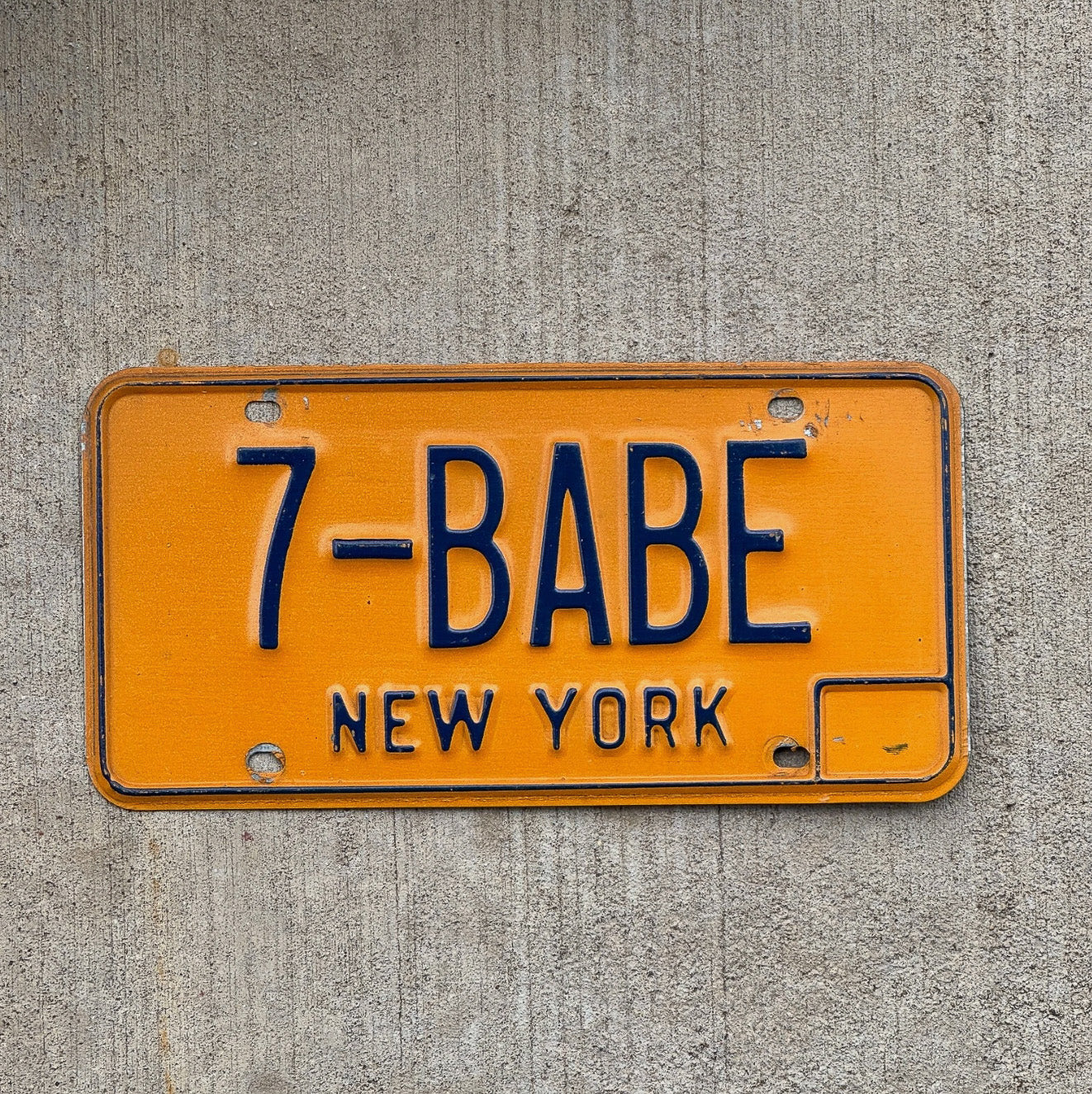 Photo of a 1973 New York Vanity License Plate Auto Tag Garage Decor Vintage Girlfriend Wife 7 BABE with original patina