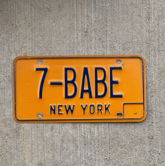 Photo of a 1973 New York Vanity License Plate Auto Tag Garage Decor Vintage Girlfriend Wife 7 BABE with original patina