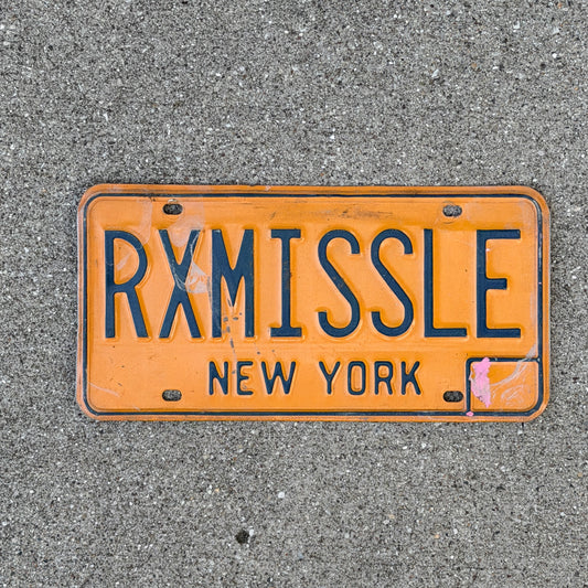 Photo of a 1973 New York Vanity License Plate Auto Tag Garage Decor Vintage Hellfire RX MISSLE with original patina
