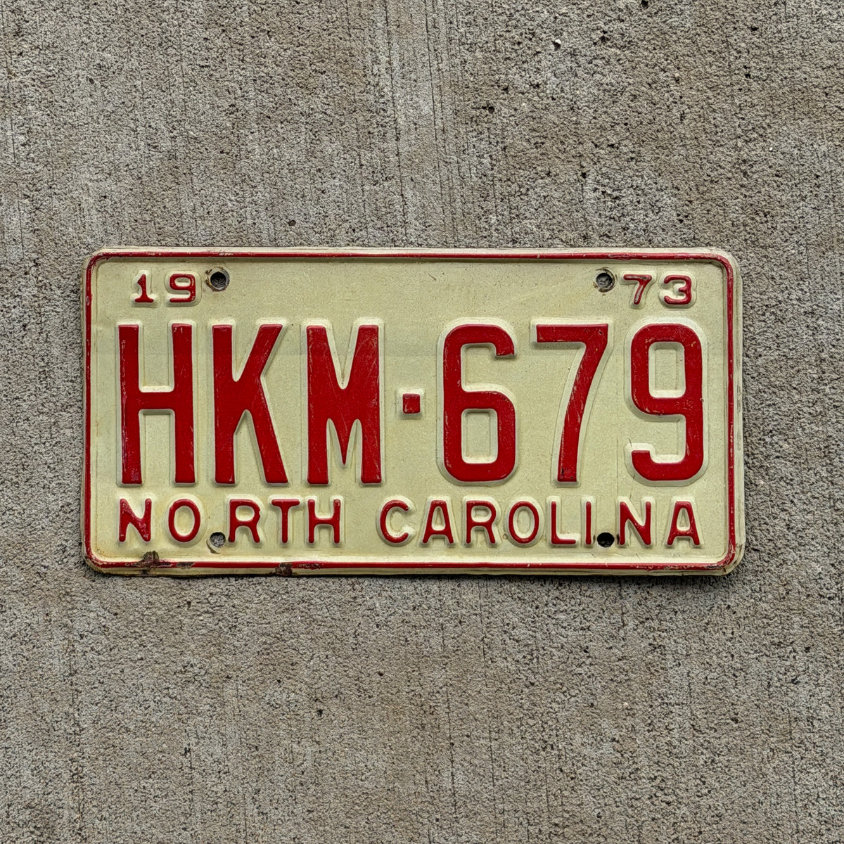 Photo of a 1973 North Carolina License Plate Auto Tag Garage Decor Vintage HKM 679 with original patina