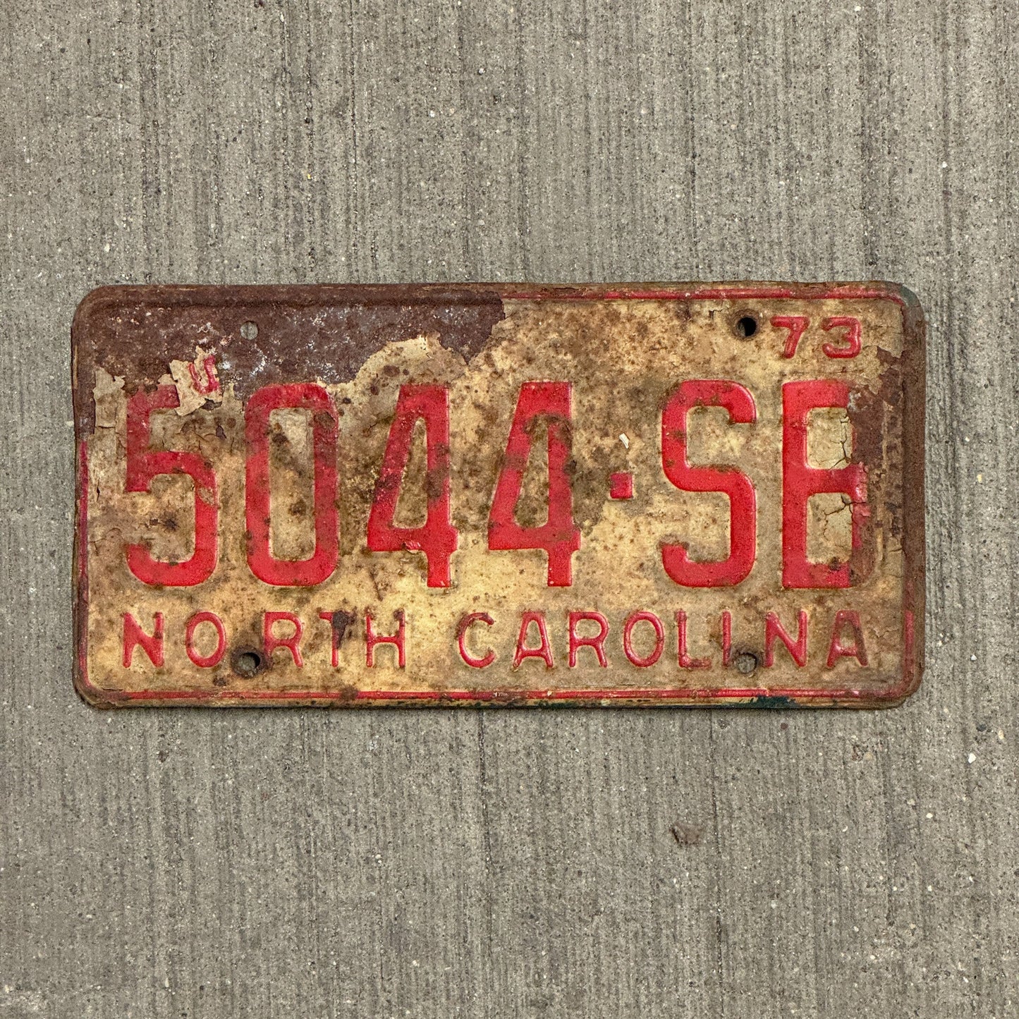 Photo of a 1973 North Carolina Truck License Plate Auto Tag Garage Decor Vintage 5044 SB with original patina