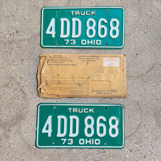 Photo of a 1973 Ohio Truck License Plate Pair Auto Tag Garage Decor Vintage With Non-Matching Envelope 4 DD 868 with original patina