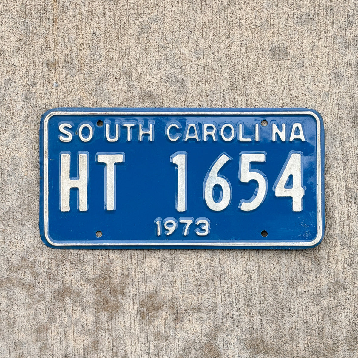 Photo of a 1973 South Carolina House Trailer License Plate Auto Tag Garage Decor Vintage HT 1654 with original patina