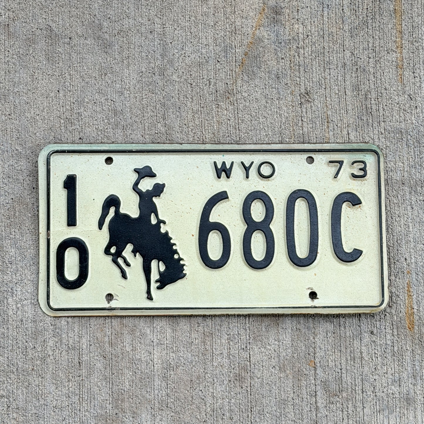 Photo of a 1973 Wyoming License Plate Auto Tag Garage Decor Vintage Cowboy Rodeo 10 680C with original patina