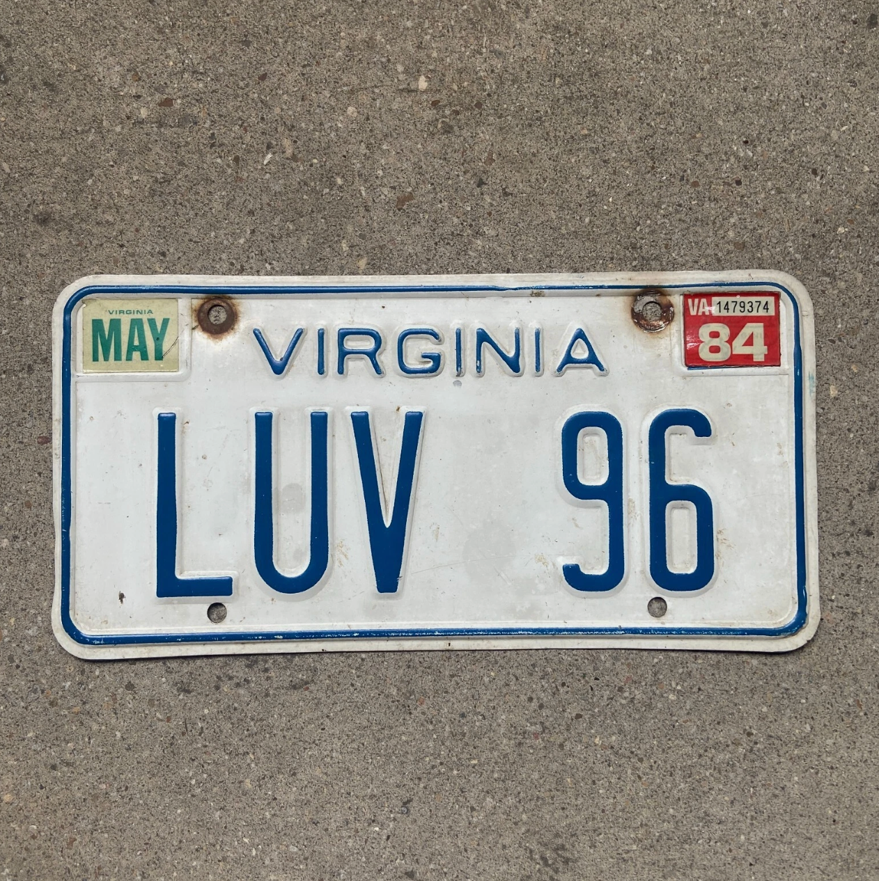 Photo of a 1973 1984 Virginia Vanity License Plate LUV 96 1996 September 6th Wedding For Lovers on a concrete background
